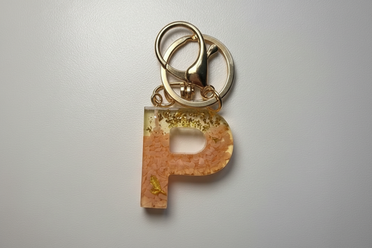 Keychain with a letter 'P' on a light gray background