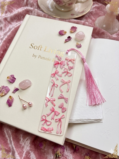 Pink bow-themed bookmark on a book with decorative elements, sold at Pennie's Little Keepsakes
