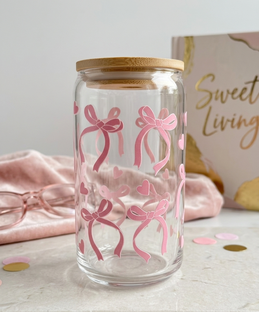 Glass jar with pink bow designs and a wooden lid on a light surface , sold at Pennie's Little Keepsakes