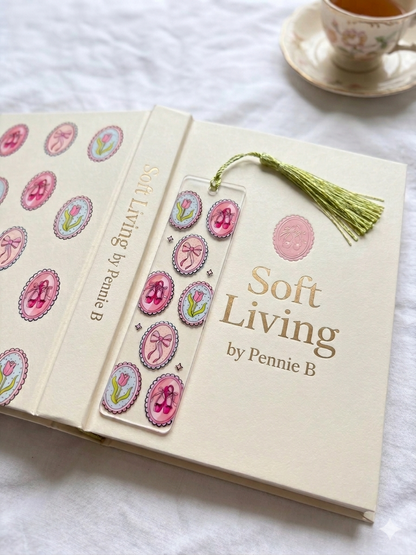 Book titled 'Soft Living by Pennie B' with decorative stickers and a bookmark on a white surface.